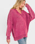 Woman wearing a pink sweater on a white background