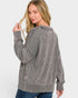 Woman wearing a gray sweater on a white background