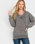 Woman wearing a gray sweater with a white background