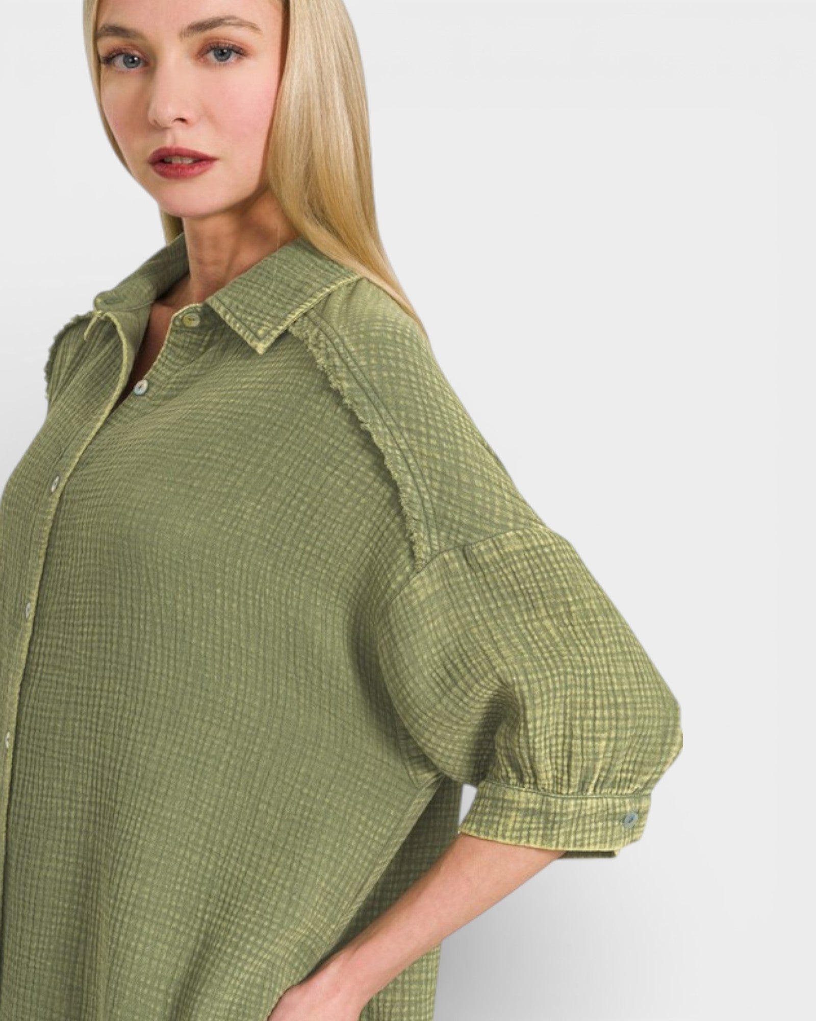 Woman wearing a green checkered shirt against a white background