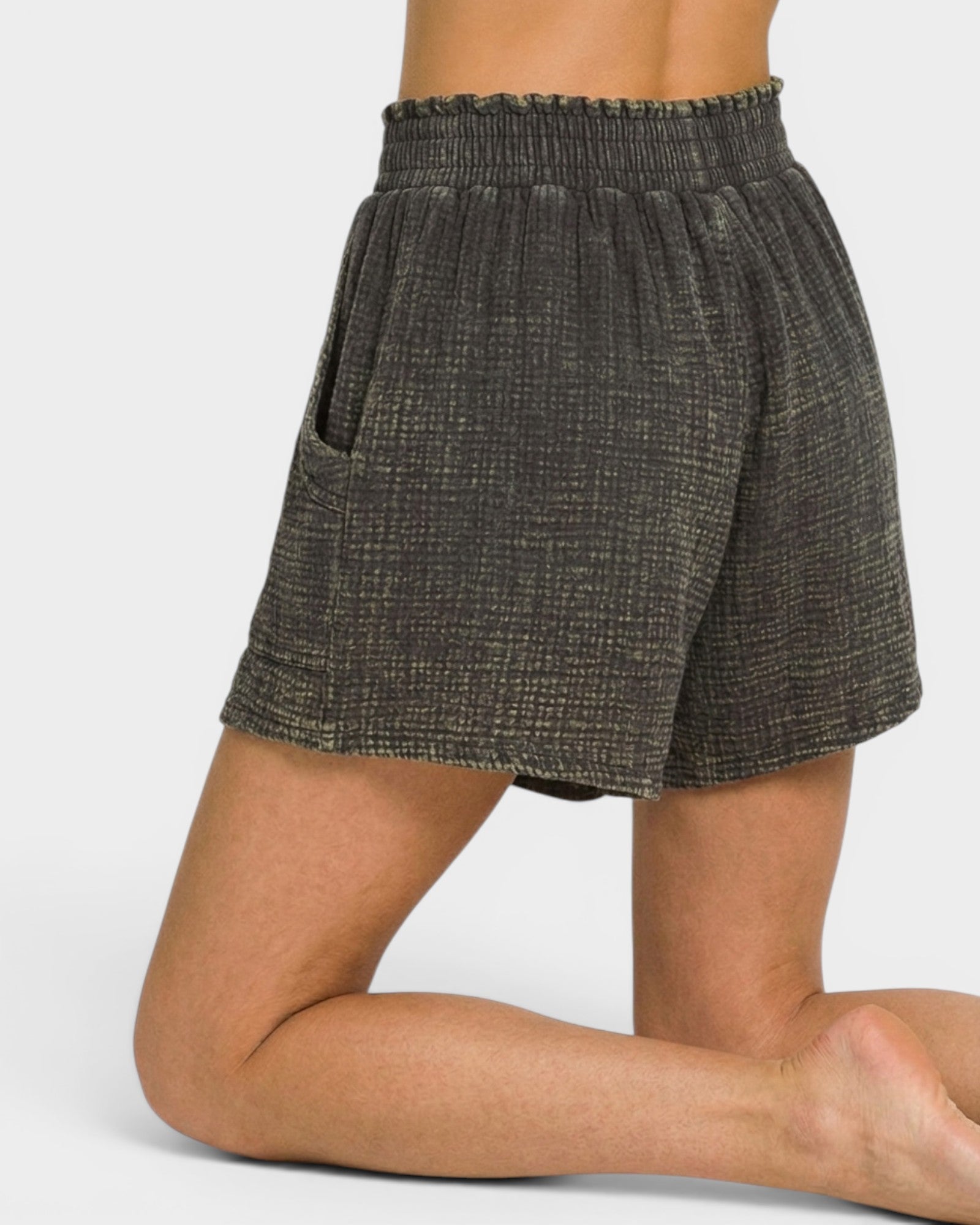 Textured shorts worn by a person on a plain background