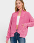Woman wearing a pink cardigan over a white top and blue jeans on a white background