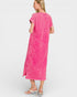 Woman wearing a pink dress on a white background