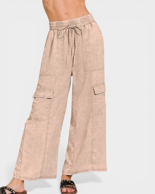 Beige cargo pants worn by a person on a white background