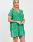 Woman wearing a green dress against a white background