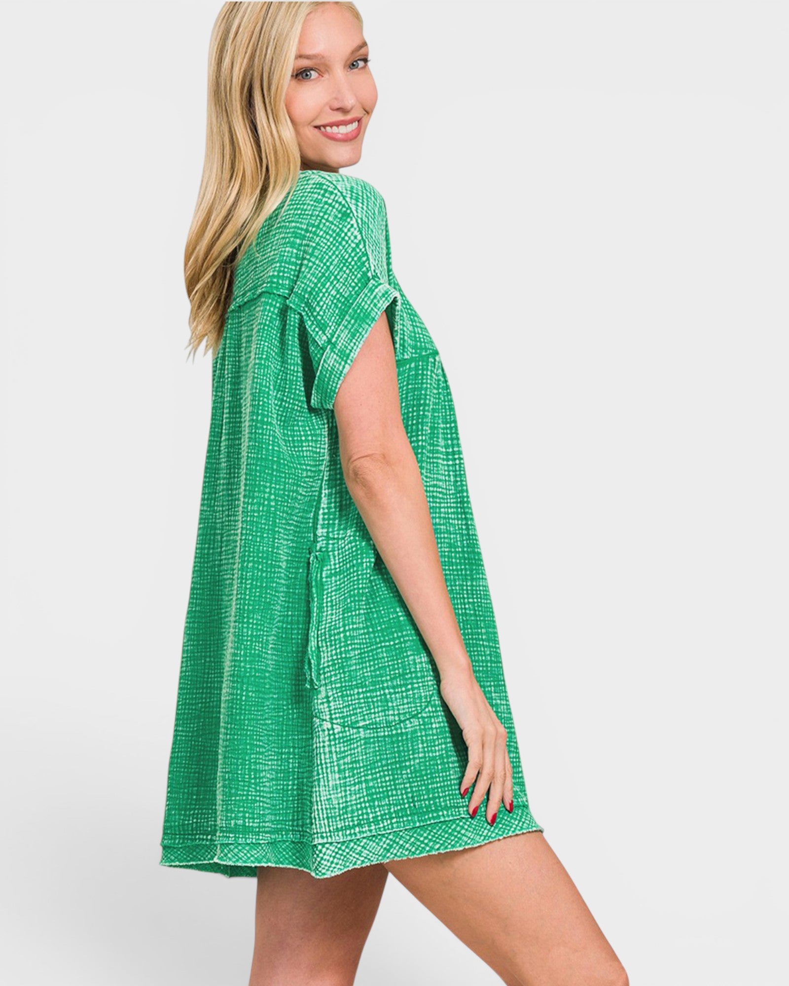 Woman wearing a green checkered dress on a white background