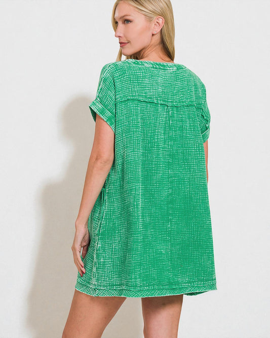 Woman wearing a green checkered dress against a white background