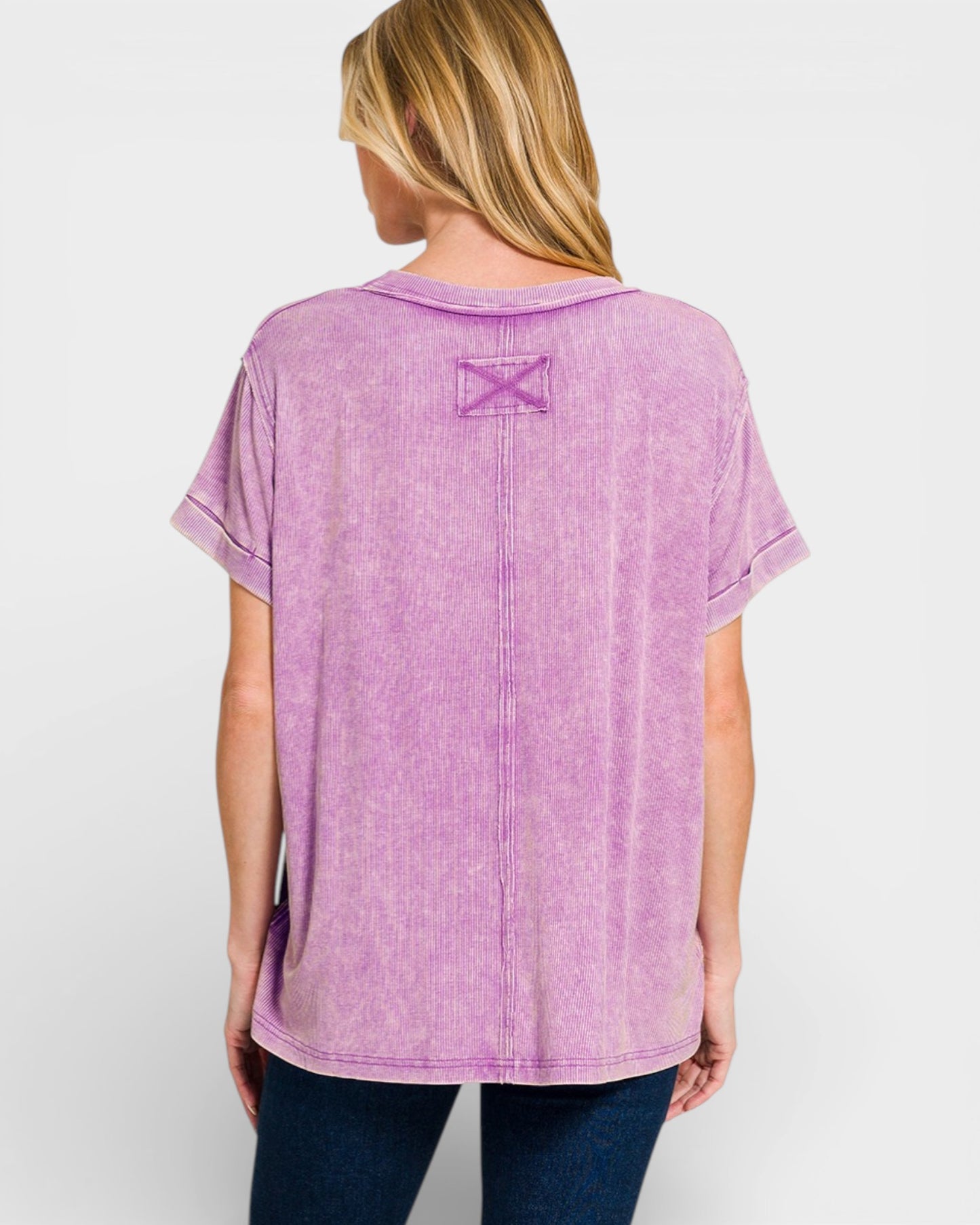Person wearing a purple t-shirt with a star design on the back against a white background