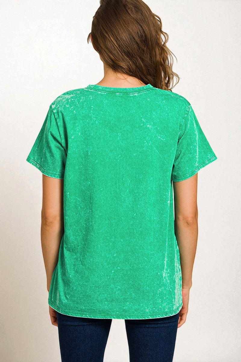 Green t-shirt worn by a person on a white background