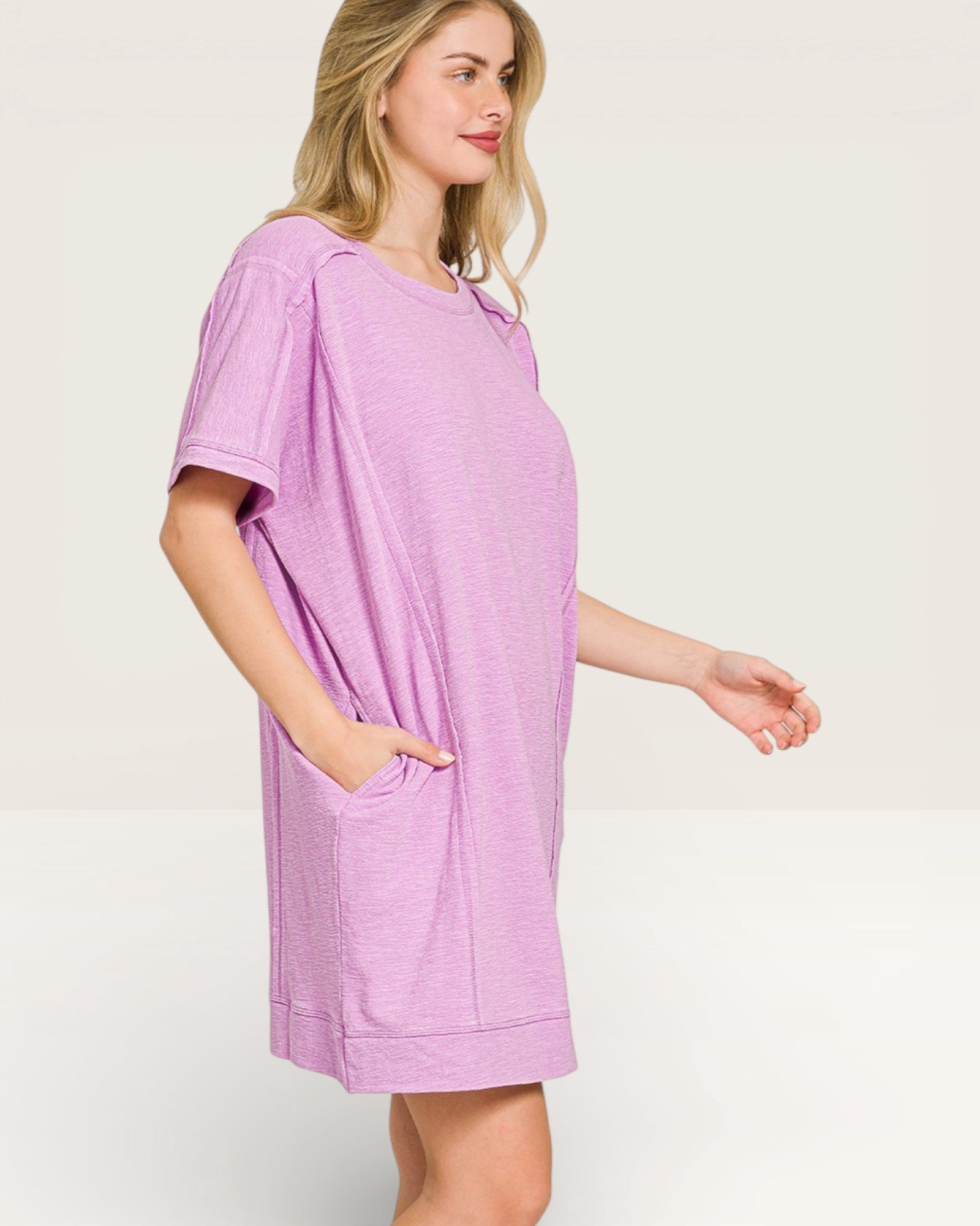 Woman wearing a purple dress with a plain background