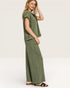 Woman wearing a green outfit with wide-leg pants on a white background