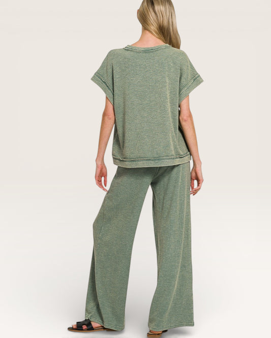 Person wearing a green outfit on a white background