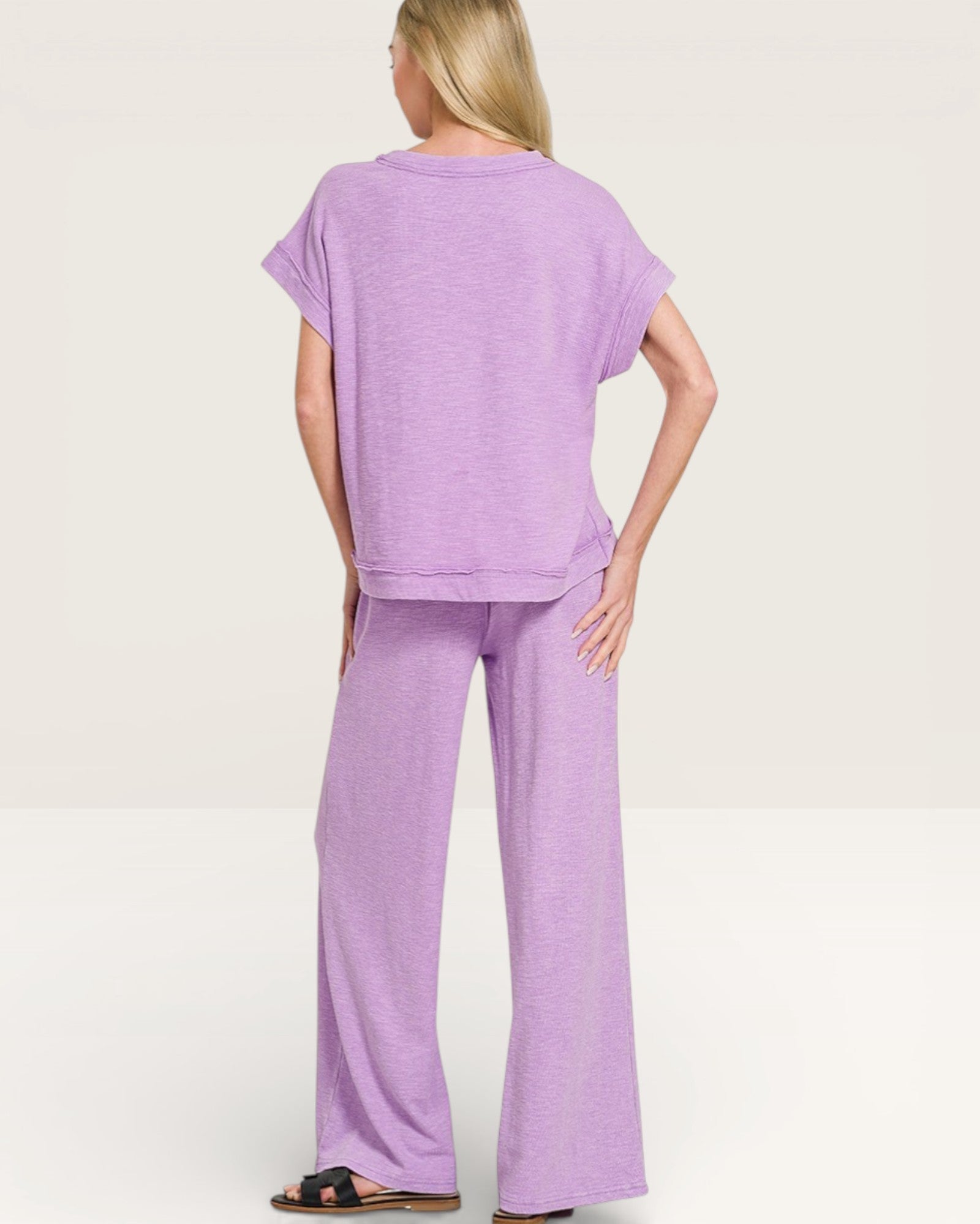 Woman wearing a purple outfit on a white background