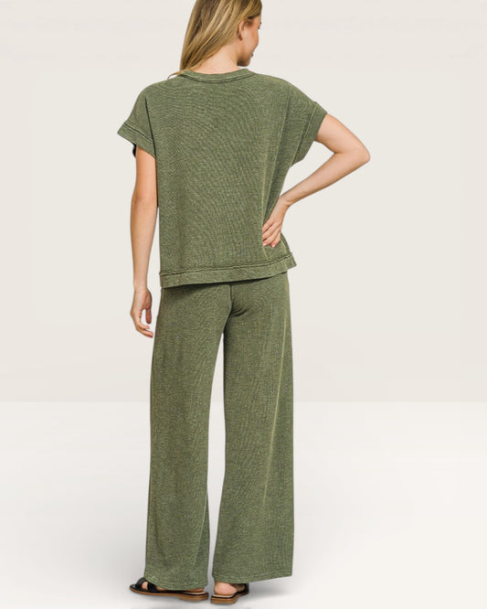 Woman wearing a green outfit with a plain background