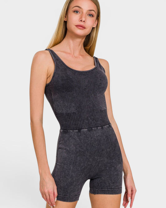 Woman wearing a dark gray sleeveless top and shorts set on a white background