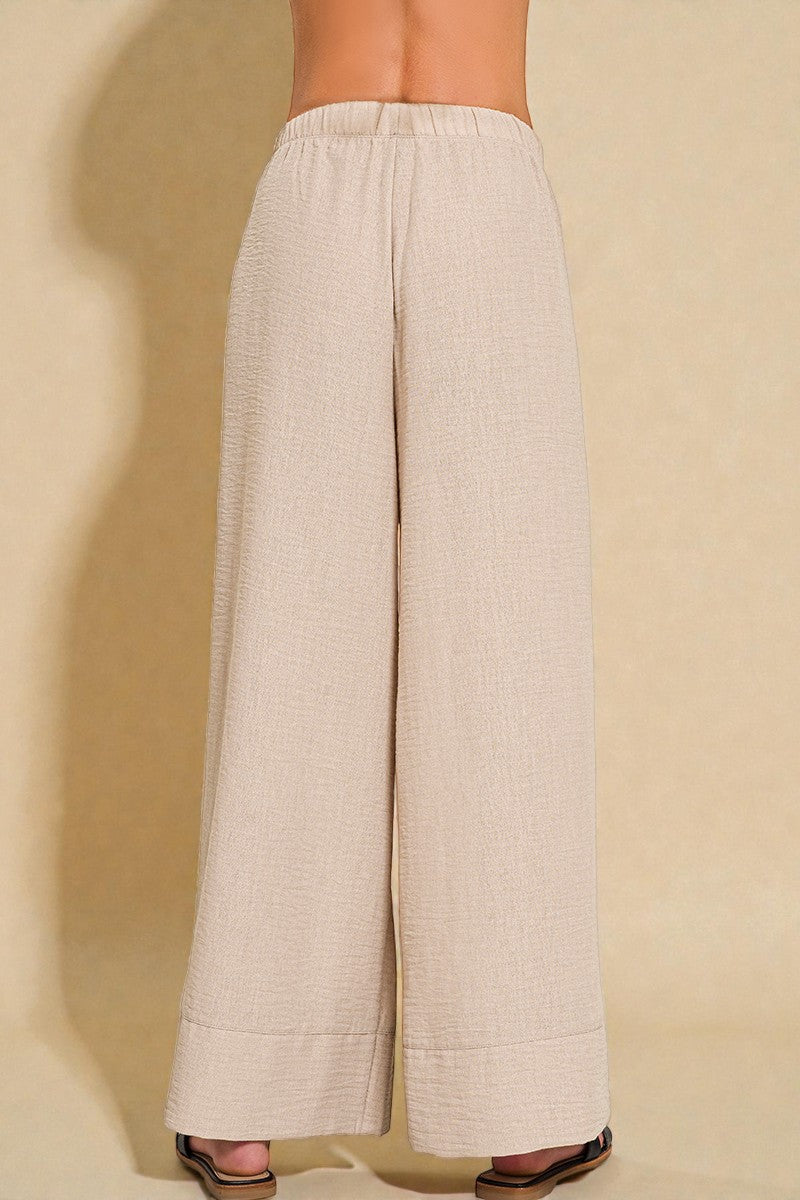 Beige wide-leg pants on a beige background