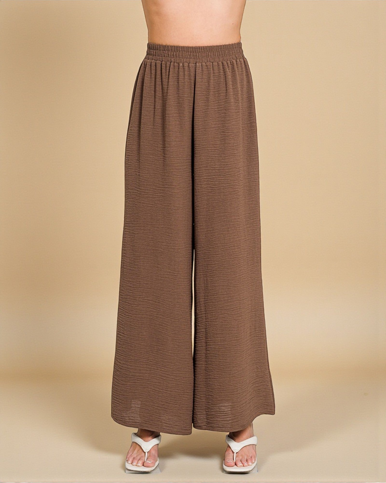 Brown wide-leg pants on a beige background