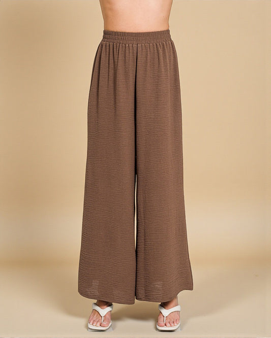 Brown wide-leg pants on a beige background