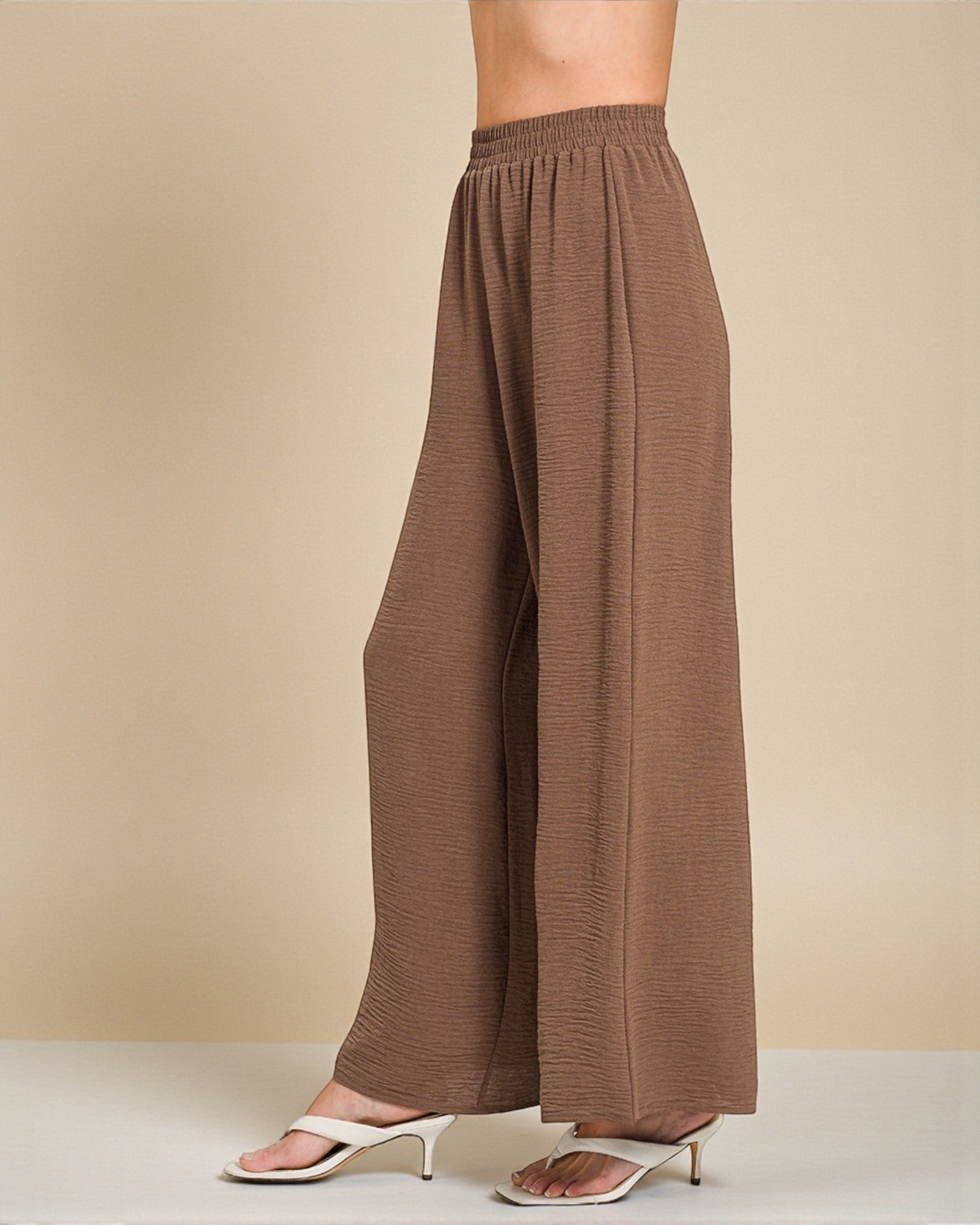 Brown wide-leg pants on a beige background