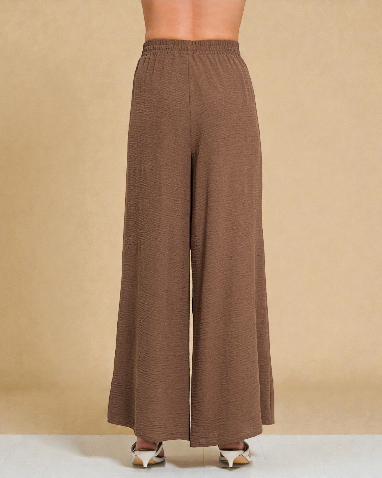 Brown wide-leg pants on a beige background