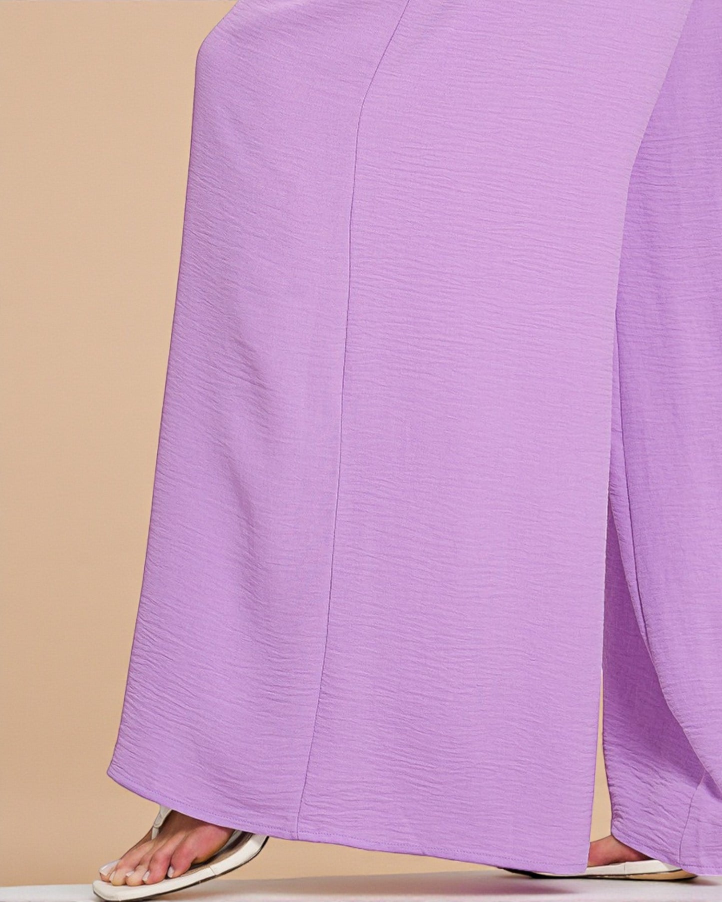 Purple pants on a beige background