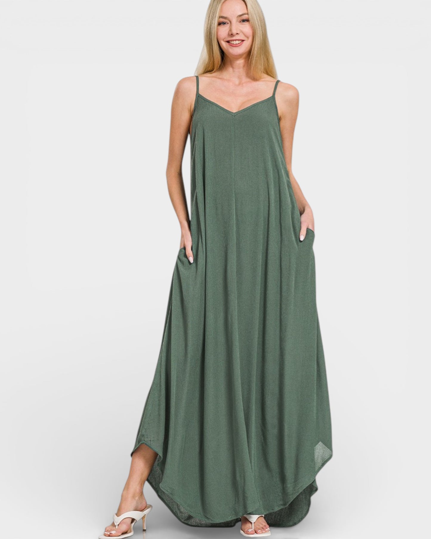 Woman wearing a green maxi dress on a white background