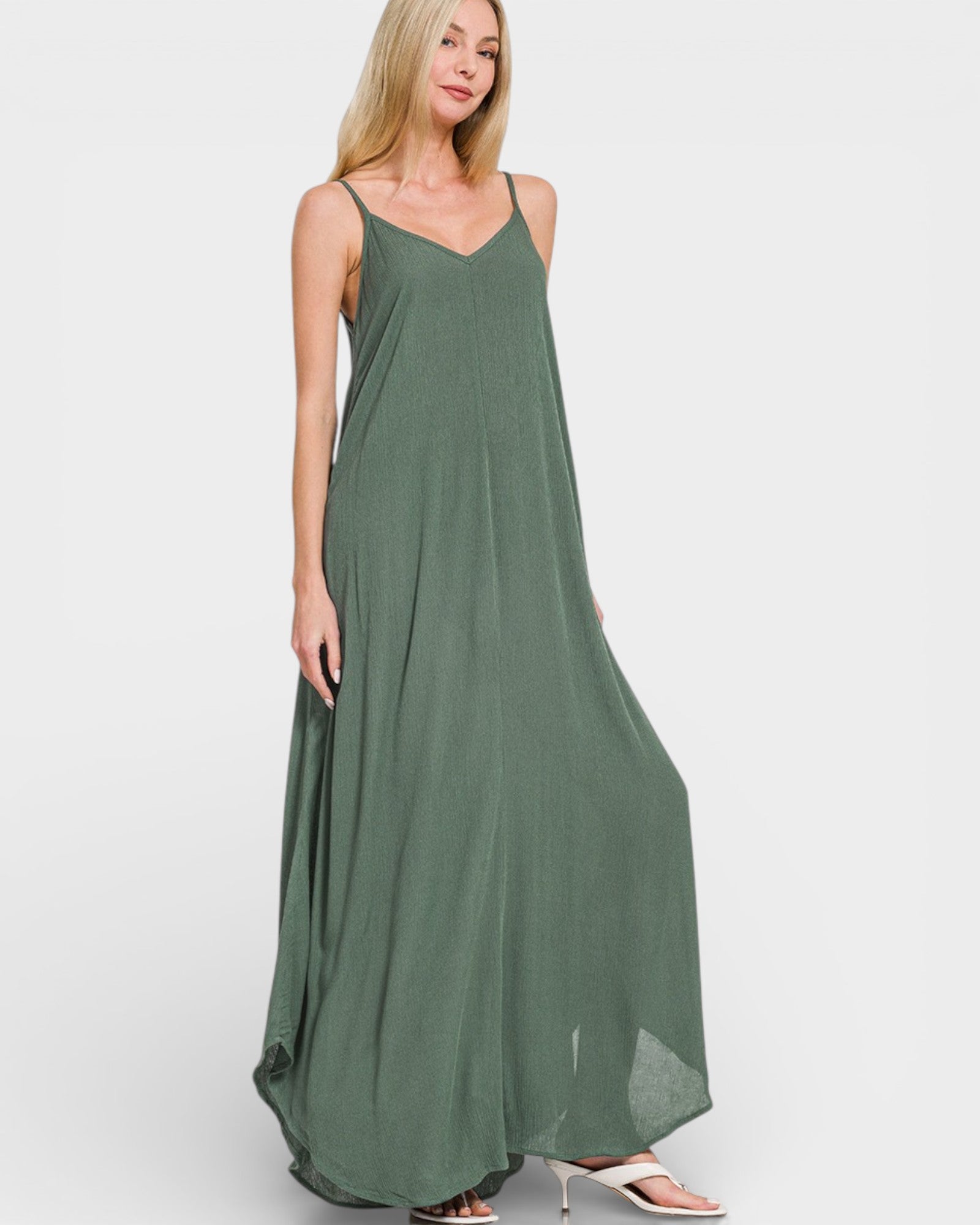 Woman wearing a green maxi dress on a white background