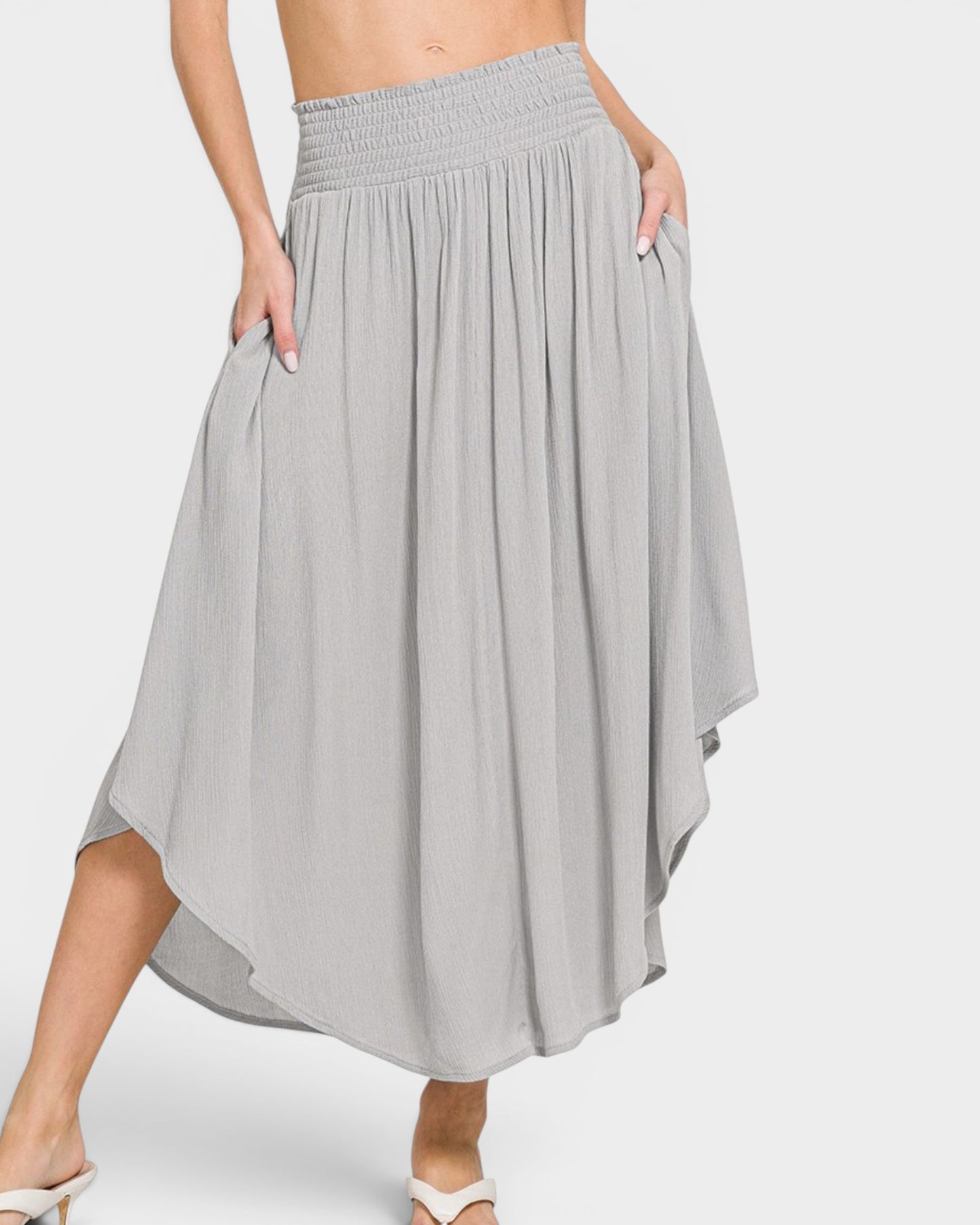 Gray skirt worn by a person on a white background