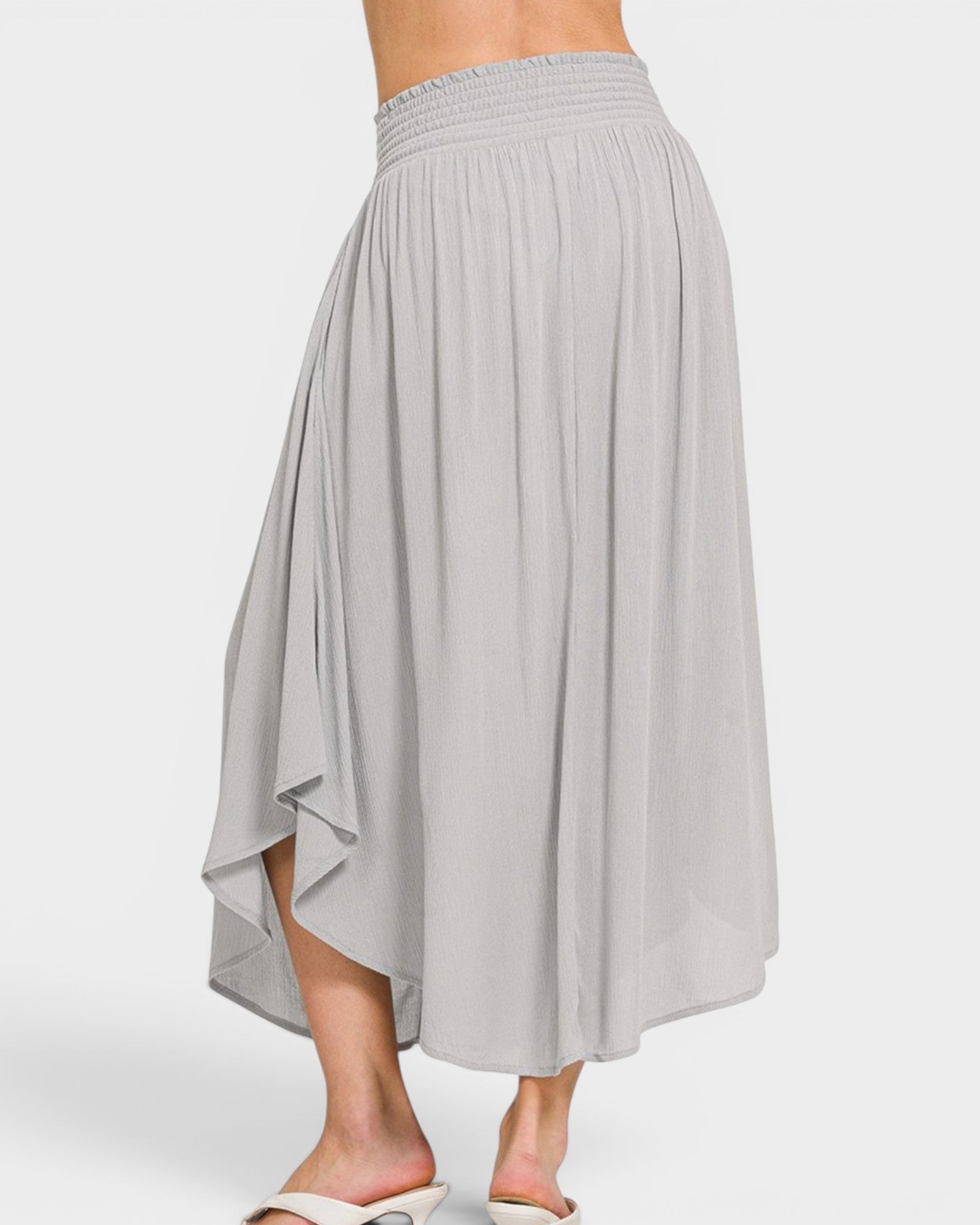 Gray skirt worn by a person on a white background