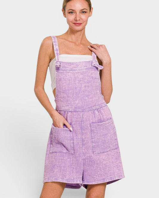 Woman wearing a purple checkered dress against a white background