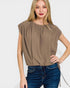 Woman wearing a brown top and blue jeans on a white background