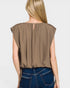Brown sleeveless top worn by a person on a plain background