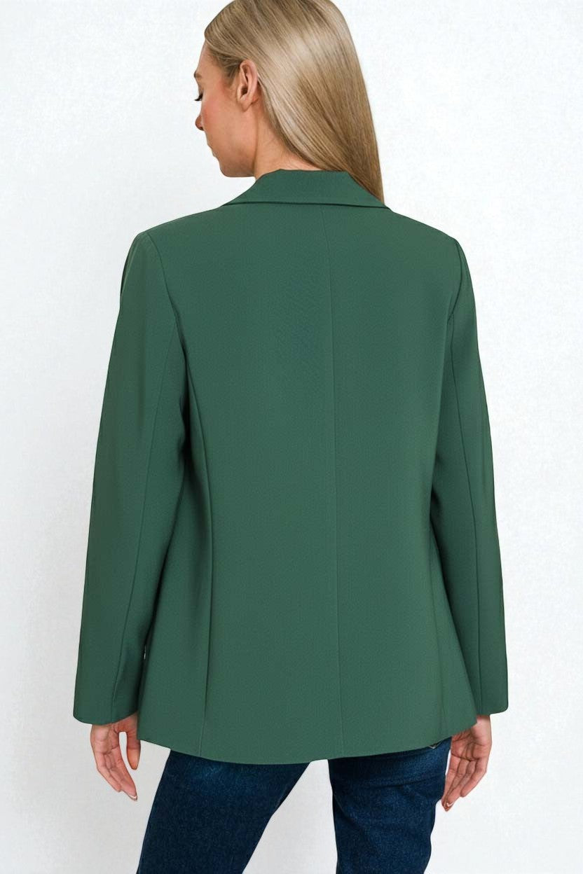 Green blazer worn by a person on a white background