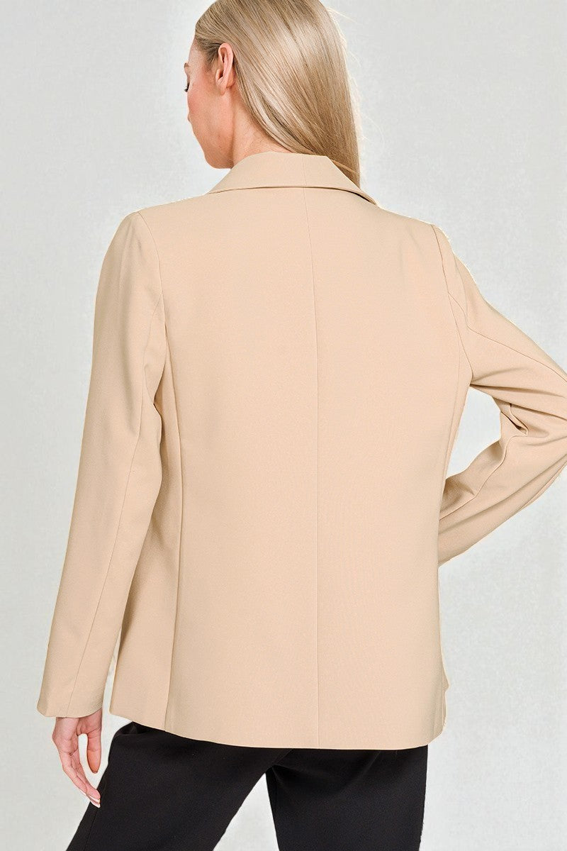Beige blazer worn by a person on a plain background