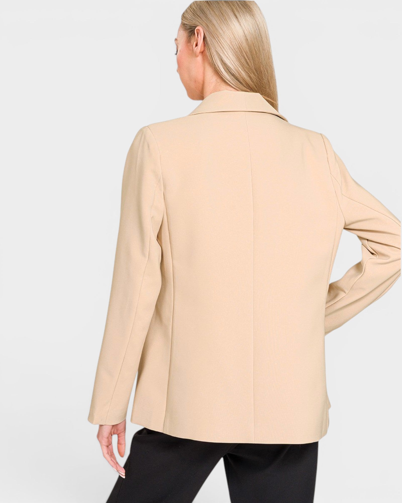 Beige blazer worn by a person on a light gray background