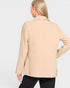 Beige blazer worn by a person on a light gray background