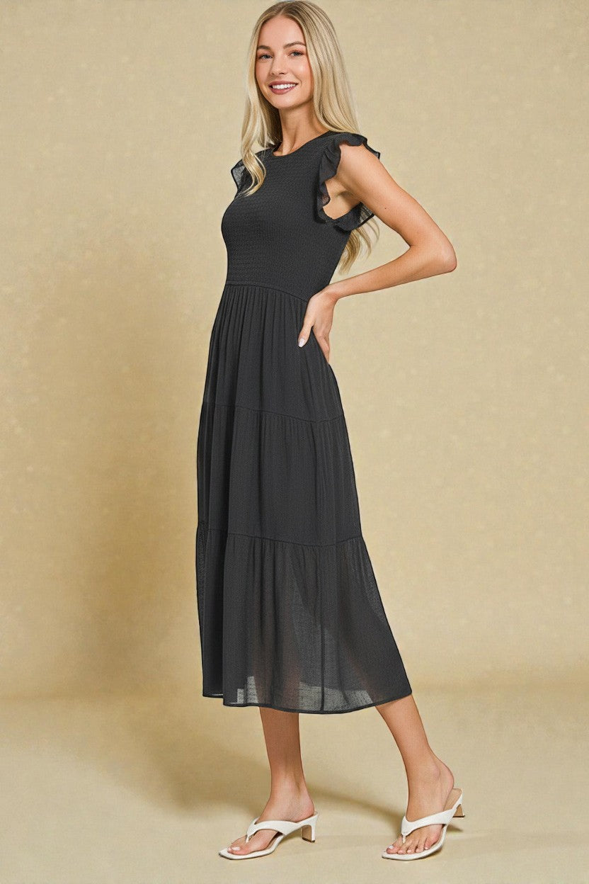 Woman wearing a black dress against a beige background