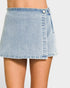 Light blue denim skirt worn by a person on a plain background