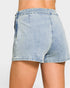 Light blue denim shorts worn by a person on a plain background
