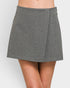 Gray skirt worn by a person on a white background