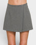 Gray skirt worn by a person on a white background
