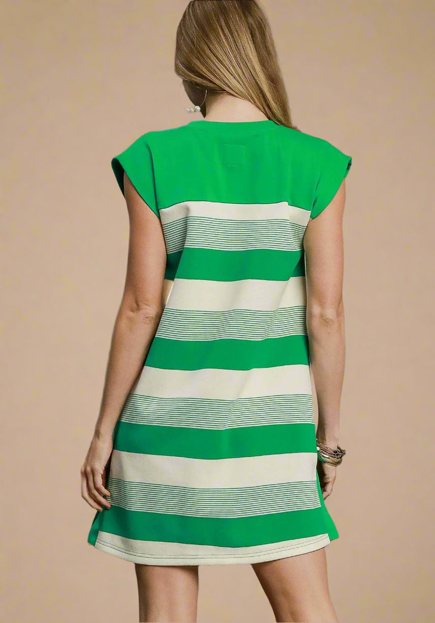 Green and white striped dress on a model against a beige background