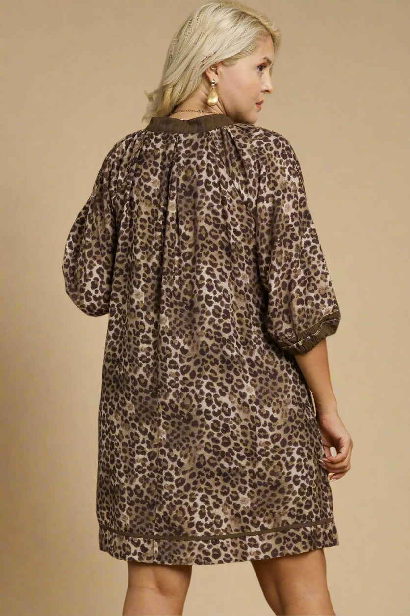 Woman wearing a leopard print dress against a beige background