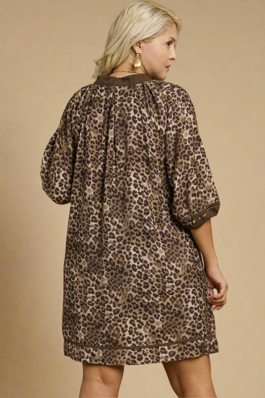 Woman wearing a leopard print dress against a beige background