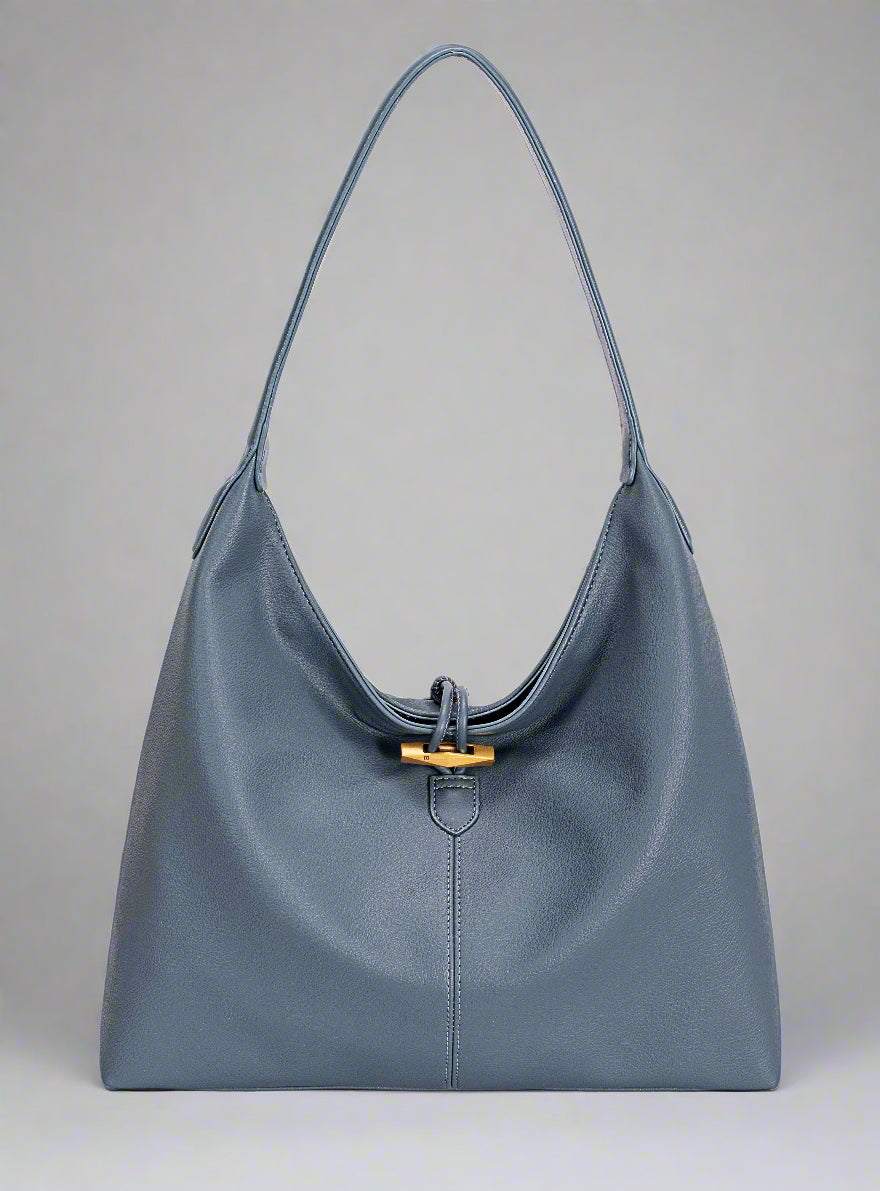 Blue handbag with a gold clasp on a white background
