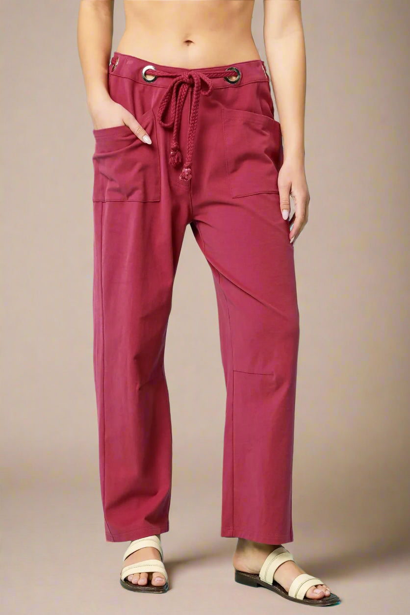 Red pants worn by a person on a beige background