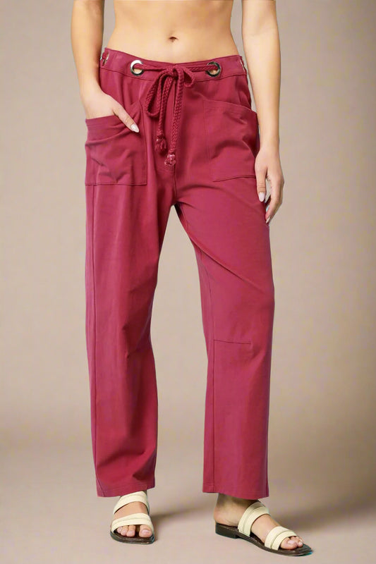 Red pants worn by a person on a beige background