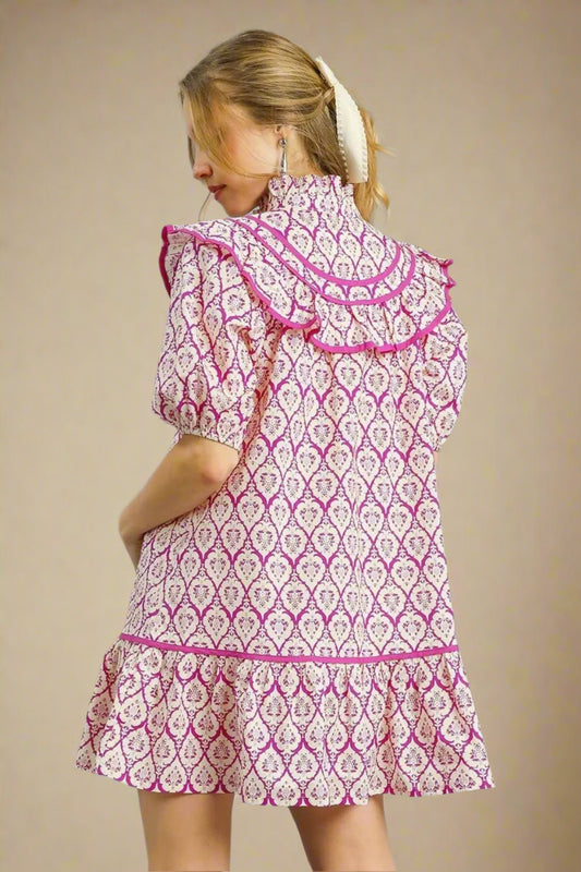 Woman wearing a pink and white patterned dress on a beige background