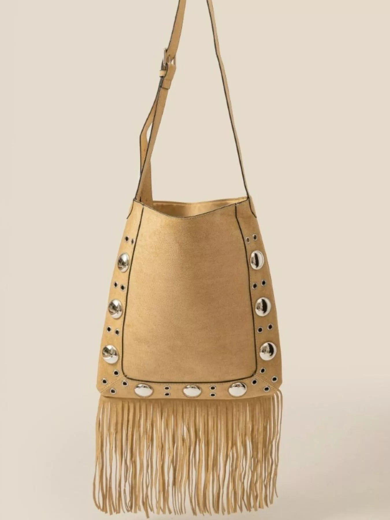 Beige handbag with fringe and stud details on a beige background