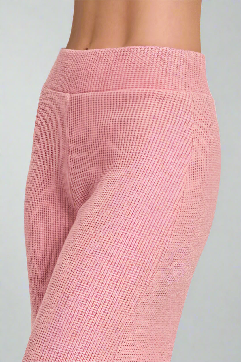 Light pink textured leggings on a white background